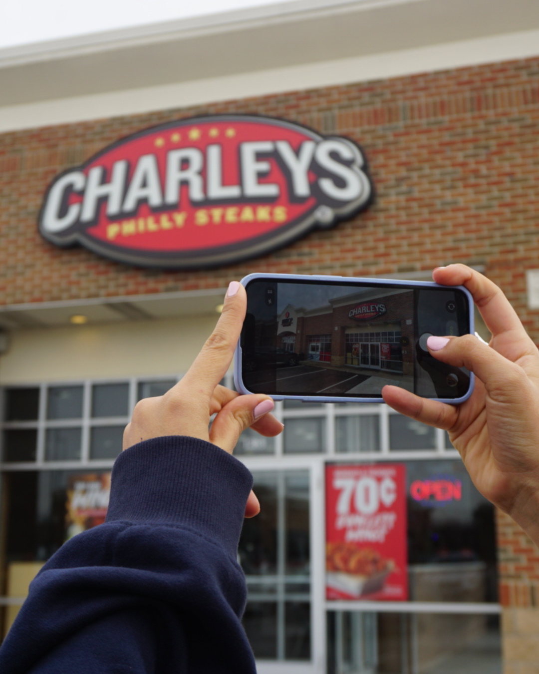Vuer taking a site verification photo at a Charleys Philly Steaks location